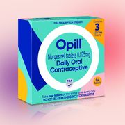 a box of opill set against a pink and purple background
